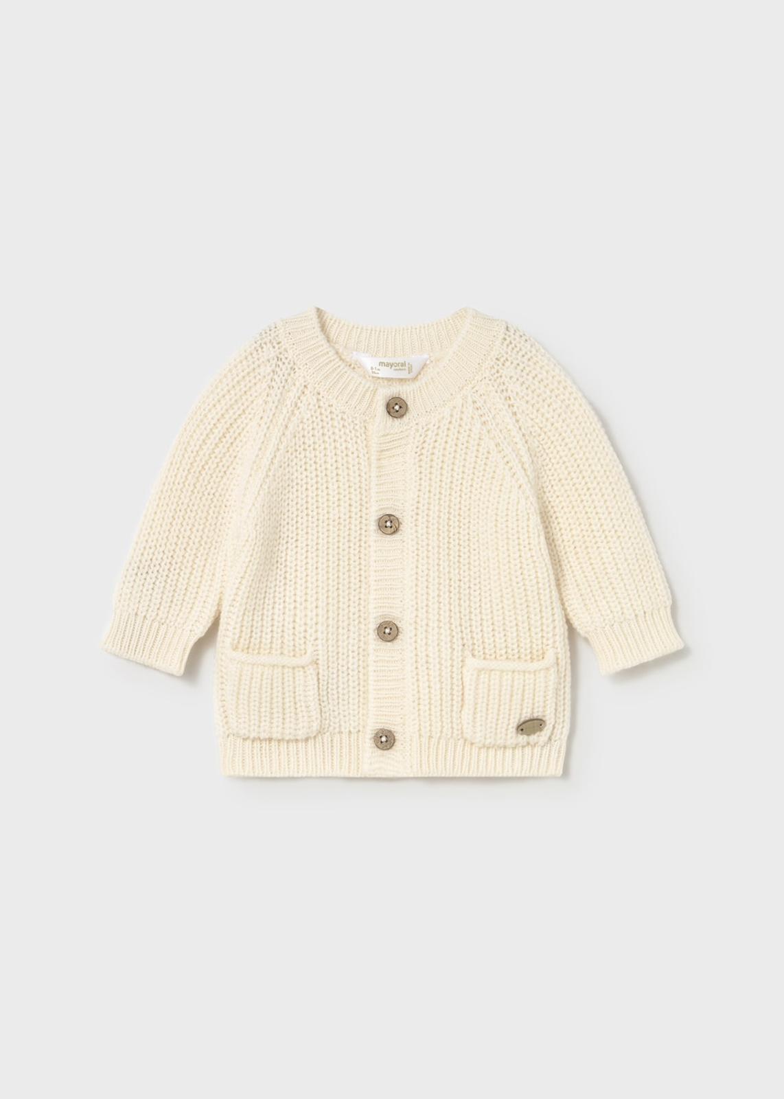 Cardigan in maglia con bottoni unisex di colore crema con tasche frontali e morbido tessuto