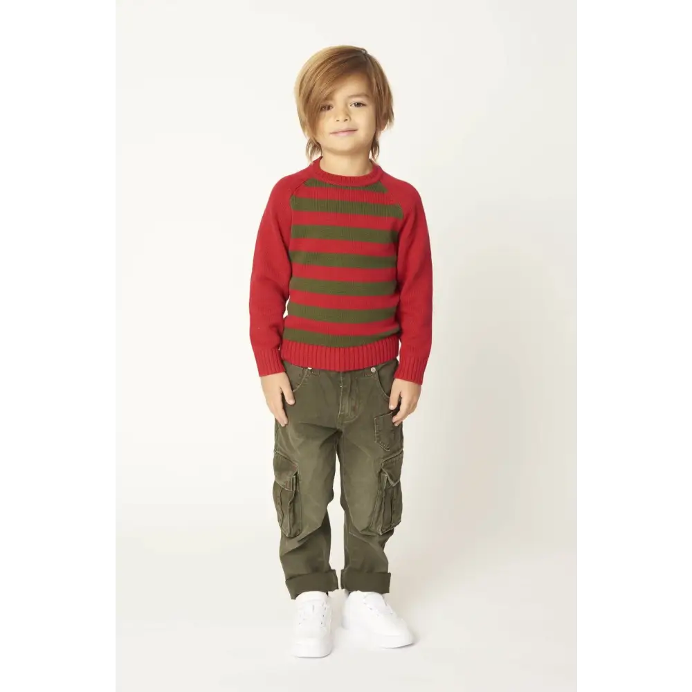 Ragazzo che indossa pantaloni cargo bambino verde militare con tasche laterali risvoltati e sneakers bianche