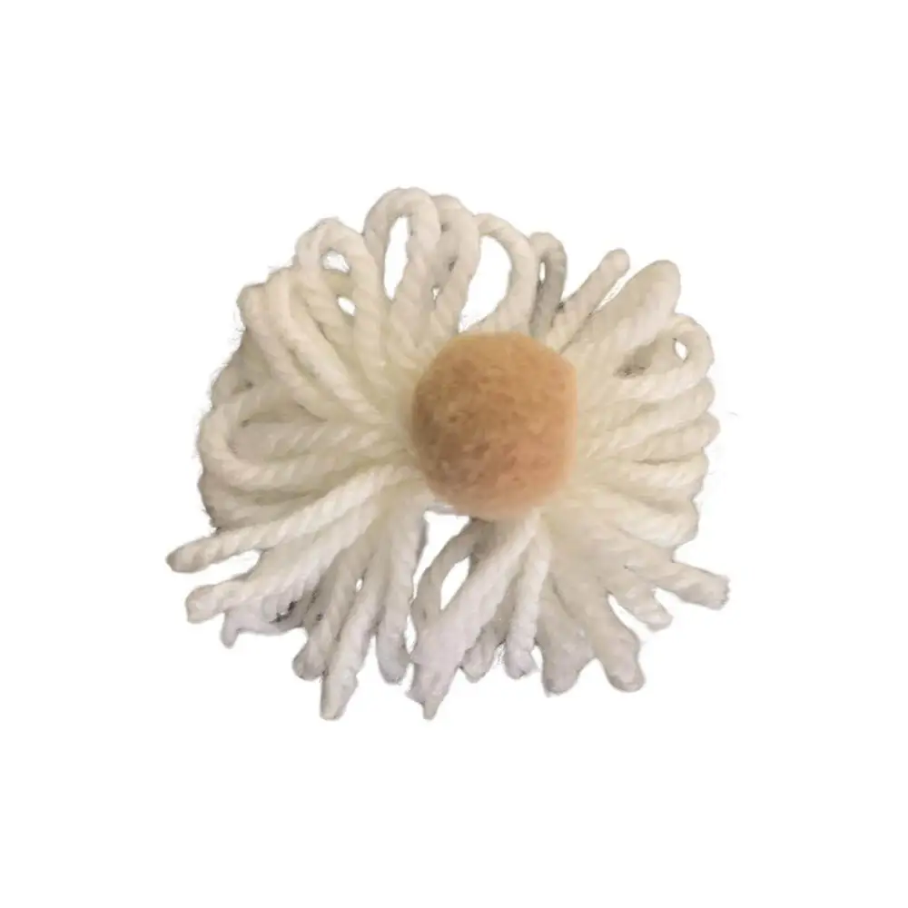 Dettaglio pompon bianco con centro beige su maglione invernale morbido, cardigan bambina Paris Hilton