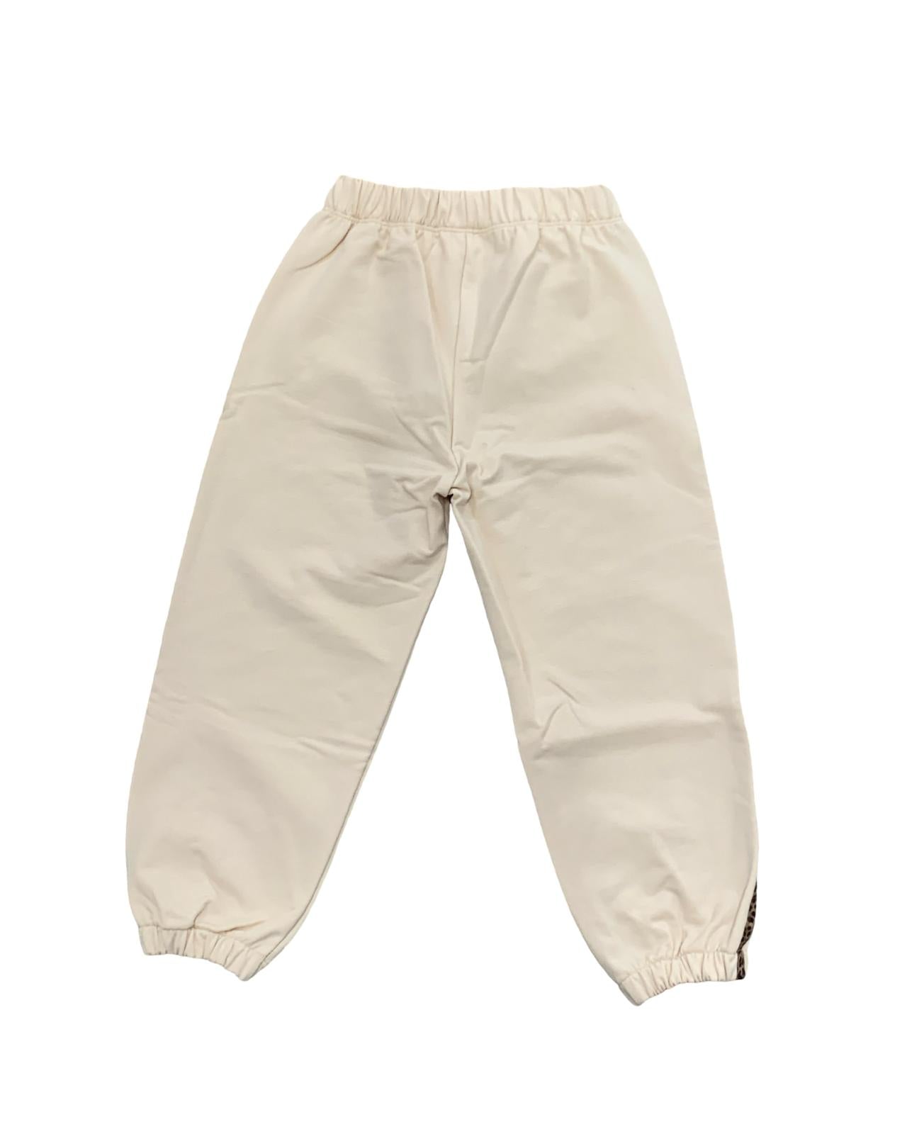 Pantaloni beige della tuta bimba beige due pezzi con elastico in vita e orlo arricciato