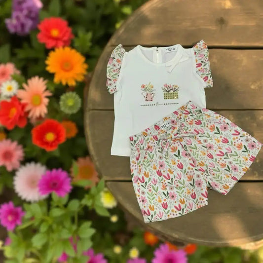 Completo Y-Clù per bambina con maglietta e pantaloni fiori bimba a fantasia colorata su sfondo legno