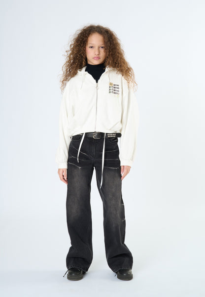Jeans neri larghi ragazza di Tobetoo, abbinati a un maglione bianco con zip e collo alto